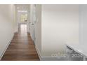 Bright hallway with hardwood floors leading to other rooms at 3950 Rothwood Ln, Harrisburg, NC 28075
