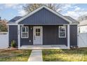 Front view of a charming house with gray siding and a light gray door at 429 Dare Dr, Charlotte, NC 28206