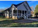 Gray house with a wrap-around porch and landscaping at 4541 Hall Dairy Rd, Claremont, NC 28610