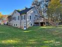 Gray house with stone foundation, a deck, and a yard at 4541 Hall Dairy Rd, Claremont, NC 28610