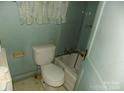 Bathroom with old fixtures and worn flooring at 523 Hoyle St, Dallas, NC 28034