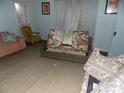 Living room with old furniture and worn carpet at 523 Hoyle St, Dallas, NC 28034