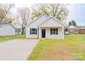 Newly built house featuring gray siding, black shutters, and a small front yard at 805 Cedar St, Salisbury, NC 28144