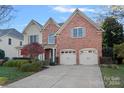 Two-story home with three car garage and mature landscaping at 10232 Squires Way, Cornelius, NC 28031