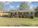 Brick ranch house with carport, small porch, and yard at 1314 Frederick St, Shelby, NC 28150