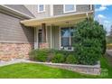 Inviting front porch with a sitting bench and well-maintained landscaping at 205 Rustling Waters Dr, Mooresville, NC 28117