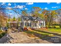 House with carport and mature trees in front at 230 Feimster St, Statesville, NC 28677