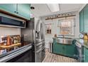 Galley kitchen with stainless steel appliances and green cabinets at 230 Feimster St, Statesville, NC 28677
