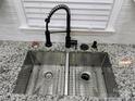 Modern kitchen with stainless steel sink, black faucet, and granite countertops at 5034 Clearwater Lake Rd, Mount Holly, NC 28120