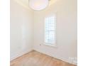 Cozy bedroom with hardwood floors and plantation shutters at 931 Hawthorne Bridge Ct, Charlotte, NC 28204