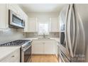 Modern kitchen with stainless steel appliances and white shaker cabinets at 931 Hawthorne Bridge Ct, Charlotte, NC 28204