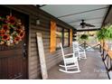 Inviting front porch with rocking chairs and a sunflower wreath at 13538 Pine Harbor Rd, Charlotte, NC 28278