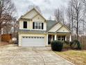 Two-story house with a large front yard, driveway, and attached garage at 141 Byers Rd, Troutman, NC 28166