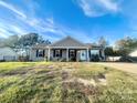 Ranch style house with front porch and a grassy yard at 1411 Foxbrook Cir, Lancaster, SC 29720