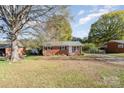 Brick ranch house with a large yard and mature trees at 206 Winona Ave, Kannapolis, NC 28081