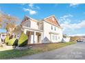 Side view of two-story house showcasing architectural details and landscaping at 1002 Trigger Dr, Indian Trail, NC 28079