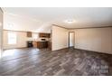 Open living room with wood-look floors and kitchen view at 3357 34Th Avenue Ne Ct, Hickory, NC 28601