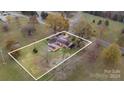 Aerial view of a ranch house with a large backyard and detached shed at 3524 Wolfe Rd, Monroe, NC 28110