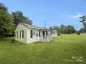 Side view of a yellow ranch home with small front porch and yard at 3630 Old Mocksville Rd, Salisbury, NC 28144