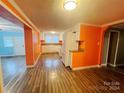 Kitchen with white cabinets, orange walls, and hardwood floors at 3630 Old Mocksville Rd, Salisbury, NC 28144