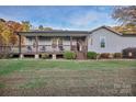 Gray exterior, covered porch, and landscaped yard at 37443 Melton Rd, Albemarle, NC 28001