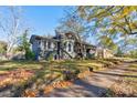 Gray craftsman home with a large yard and mature trees at 600 W Warren St, Shelby, NC 28150