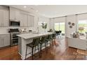 Modern kitchen with gray cabinets, island, and stainless steel appliances at 109 Obadiah Ct, Mooresville, NC 28115