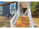 Steps leading up to a wooden front porch with white railings at 1100 Turkey Creek Ridge Rd, York, SC 29745