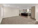 Open living room with carpet flooring and a view into the kitchen at 1100 Turkey Creek Ridge Rd, York, SC 29745