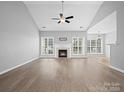 Spacious living room with hardwood floors, fireplace, and vaulted ceiling at 151 Samdusky Ln, Mooresville, NC 28117