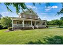Two-story home with a wrap-around porch and brick facade, set on a large lot at 1727 Will Schronce Rd, Lincolnton, NC 28092