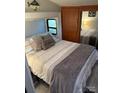 Cozy bedroom with a double bed and wooden storage at 204 Lake Tillery Trl, Mount Gilead, NC 27306