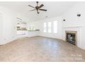 Spacious living room with tile floors, a fireplace, and kitchen views at 3916 Cedarbark Dr, Matthews, NC 28105