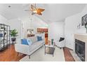Bright living room features hardwood floors, a fireplace, and a view into the kitchen at 4875 Polo Gate Blvd, Charlotte, NC 28216