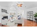 Spacious living room with hardwood floors, fireplace, and access to sunroom at 4875 Polo Gate Blvd, Charlotte, NC 28216
