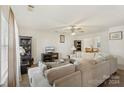 Spacious living room with beige sectional sofa and a large TV at 5502 Henderson Oaks Dr, Charlotte, NC 28269