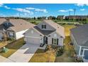 Ranch home with neutral siding, two-car garage, and manicured lawn at 797 Latrobe Dr, Iron Station, NC 28080