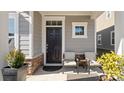 Covered front porch with seating and potted plants at 9010 Ramsford Ct, Mint Hill, NC 28227