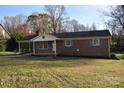 Brick ranch home with carport, light blue shutters, and a spacious yard at 104 Robinson Rd, Kings Mountain, NC 28086