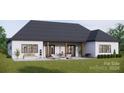 Home with covered patio, fire pit, and lush green lawn at 150A Lookout Dam Rd, Statesville, NC 28625