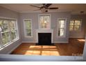 Spacious living room with hardwood floors, fireplace and large windows at 809 Pine Forest Rd, Charlotte, NC 28214