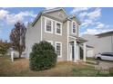 Two-story house with gray siding, gray door, and attached garage at 8601 Sawleaf Ct, Charlotte, NC 28215