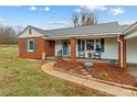 Brick ranch home with a charming front porch and landscaping at 162 Jennings Rd, Statesville, NC 28625