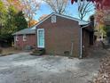 Brick house with a teal back door and a large patio at 323 Breslin St, Wadesboro, NC 28170