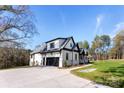 White brick home with a side view showcasing the garage and landscaping at 555 Riddle Mill Rd, Clover, SC 29710