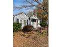 Gray one-story house with a stone chimney, covered porch, and small front yard at 805 Railroad Ave, China Grove, NC 28023