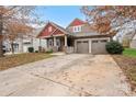 Two-story house with a two-car garage and a covered porch at 204 Planters Way, Mount Holly, NC 28120