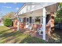 Inviting front porch with rocking chairs, perfect for relaxing at 521 E Ohio Ave, Bessemer City, NC 28016