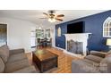 Living room with fireplace, hardwood floors, and ample seating at 521 E Ohio Ave, Bessemer City, NC 28016