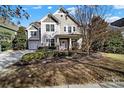 Two-story house with gray and beige siding, landscaping, and a two-car garage, viewed from the street at 1531 Kilburn Ln, Fort Mill, SC 29715